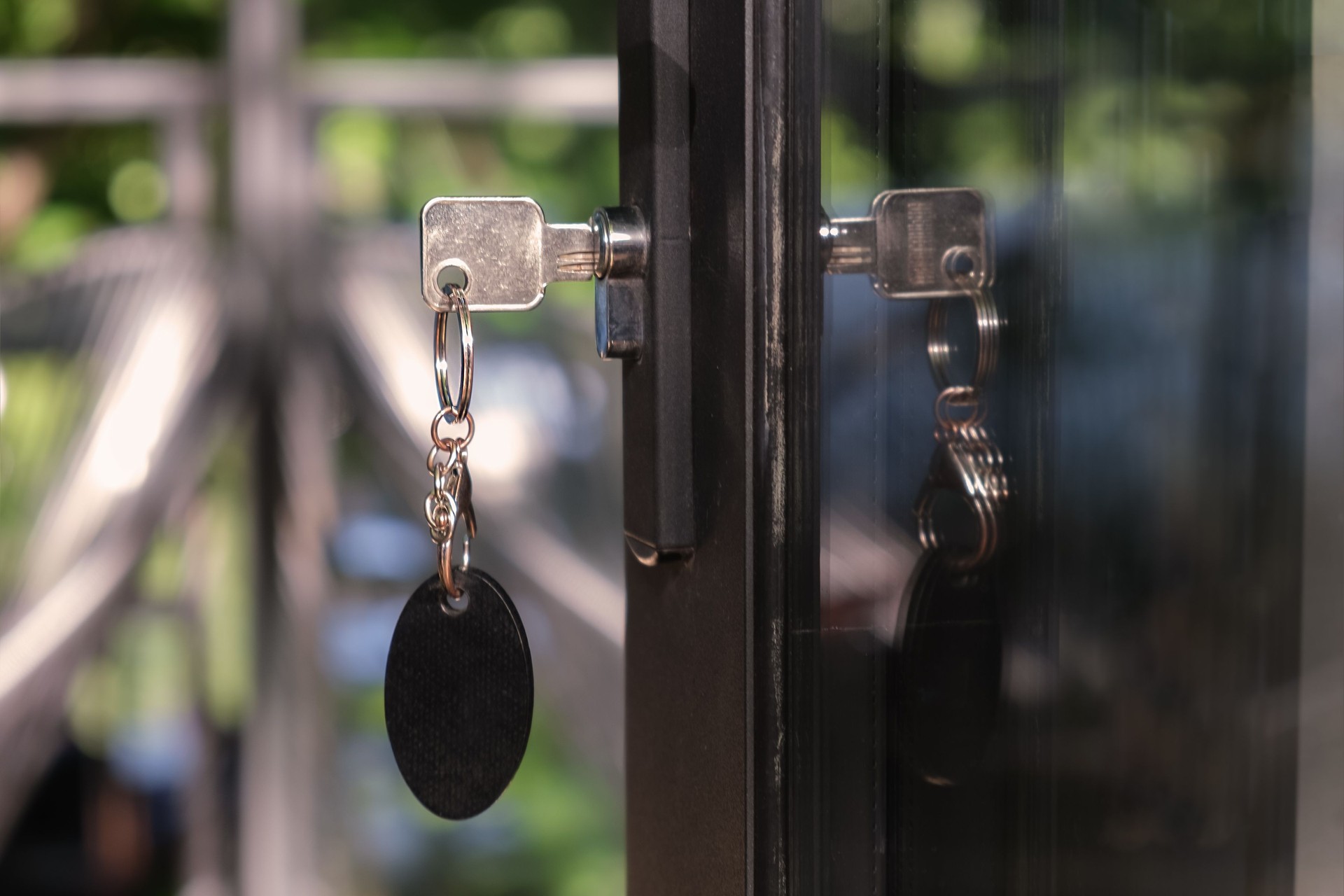 Key with a large oval keychain is inserted into the keyhole